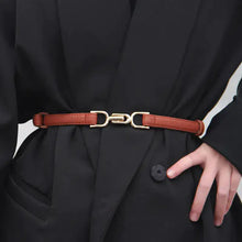 Cargar imagen en el visor de la galería, Person wearing an adjustable leather dress belt with a gold buckle, styled over a black outfit for a sophisticated look.