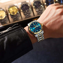 Load image into Gallery viewer, Luxury men's watch with gold accents and blue face on wrist, symbolizing sophistication and success.