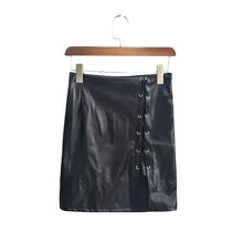 Load image into Gallery viewer, Belted vegan leather high-slit skirt, black, hanging on wooden hanger, fashion-forward style.