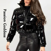 Cargar imagen en el visor de la galería, Woman wearing shiny black PU leather winter jacket, chic and stylish, showcasing glossy vegan leather fashion statement.