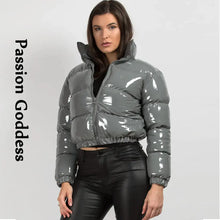 Cargar imagen en el visor de la galería, Model wearing shiny gray PU leather winter jacket with glossy finish, highlighting stylish chic design for cold weather fashion.