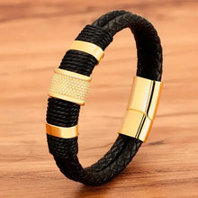 Cargar imagen en el visor de la galería, Men's woven leather bracelet with gold-tone stainless steel accents on wooden surface.