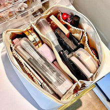 Cargar imagen en el visor de la galería, High-capacity leather cosmetic organizer filled with makeup products and skincare items, showcasing its ample storage and organized compartments.