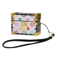 Cargar imagen en el visor de la galería, Stylish brown leather AirPods Pro case with a strap, featuring gold accents and colorful design elements for elegant protection.