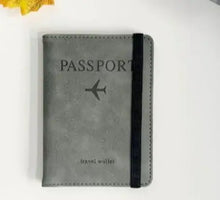 Cargar imagen en el visor de la galería, Alt Tag: Stylish leather passport holder with RFID-blocking feature for secure travel, featuring black strap and passport imprint.