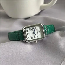 Cargar imagen en el visor de la galería, Retro women's classic quartz watch with green vegan leather strap on a soft fabric background.