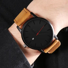 Cargar imagen en el visor de la galería, Black dial quartz watch with vegan leather strap on wrist, showcasing elegant design and precise timekeeping for both men and women.