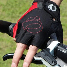 Cargar imagen en el visor de la galería, Close-up of a hand wearing black and red cycling gloves gripping bike handlebars. Provides comfort and protection for cyclists.