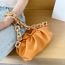 Load image into Gallery viewer, Soft leather women's cloud bag with gold chain resting on denim, showcasing luxury and elegance.