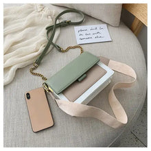 Cargar imagen en el visor de la galería, Designer leather crossbody shopping bag with a mint green flap, beige straps, and a nearby smartphone on a cream couch.
