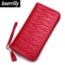 Cargar imagen en el visor de la galería, Chic red leather travel purse with textured design, featuring durable zipper closure and wrist strap for easy carrying.