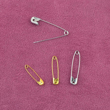Load image into Gallery viewer, Safety pins on pink fabric from eZthings Sewing Accessories Replenishment Kit for Arts and Crafts.