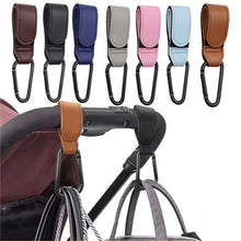 Cargar imagen en el visor de la galería, PU Leather Baby Stroller Hooks in various colors attached to stroller, holding a bag, showcasing 360-degree rotatable convenience.