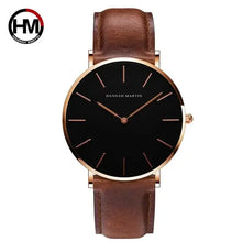 Cargar imagen en el visor de la galería, Rose gold dial leather watch with black minimalistic face and brown genuine leather strap, perfect for both casual and formal wear.