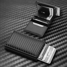 Cargar imagen en el visor de la galería, RFID Black Magic Trifold Vegan Leather Wallet showcasing open view with card slots on a carbon fiber surface.