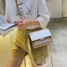 Cargar imagen en el visor de la galería, Woman with stylish designer leather crossbody shopping bag, wearing casual outfit, holding fashion magazine