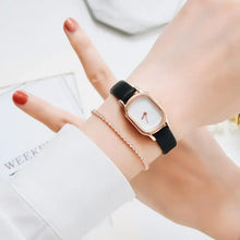 Charger l'image dans la galerie, Woman's wrist wearing Oval Dial Retro Watch with vintage design and black strap, adding timeless elegance to any outfit.