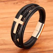 Load image into Gallery viewer, Black vegan leather bracelet with gold cross on wooden background, perfect gift for loved ones.