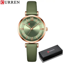 Cargar imagen en el visor de la galería, Green leather strap wristwatch with gold accents featuring a classic clockface design, shown with branded box. Stylish and water-resistant.