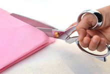 Cargar imagen en el visor de la galería, Heavy duty eZthings scissors cutting pink fabric, ideal for arts, crafts, and upholstery work, sharp blades for precision cutting.