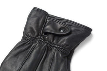 Cargar imagen en el visor de la galería, Close-up of black leather glove with button detail, showcasing soft texture and craftsmanship, touchscreen compatible for winter use.