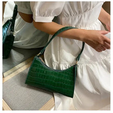 Load image into Gallery viewer, Green crocodile pattern PU leather women's shoulder bag with smooth zipper, ideal for various occasions, held by a woman in a white dress.