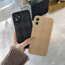 Cargar imagen en el visor de la galería, Hands holding two Retro Leather Cases in black and beige, crafted from PU leather with a checkered pattern, showcasing style and durability.