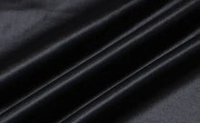 Load image into Gallery viewer, Black faux leather fabric with a sleek, smooth texture and elegant draping, ideal for creating stylish and sophisticated clothing items.