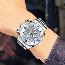 Load image into Gallery viewer, Luxury men's business watch with sleek silver design and blue accents, worn on a wrist in professional attire.