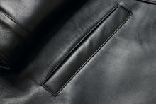 Load image into Gallery viewer, Close-up of a black leather pocket on a 34'' Raglan Reed Classic Men's Car Coat in Imported Lamb with a luxurious, soft texture.