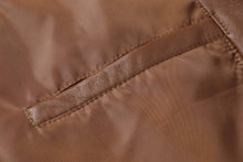 Cargar imagen en el visor de la galería, Close-up of REED Men's Premium Lambskin Leather Blazer showcasing the soft durable leather texture and stitching details.