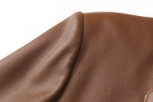 Cargar imagen en el visor de la galería, Close-up of REED Men's Premium Lambskin Leather Blazer showcasing luxurious soft-touch tan leather texture.