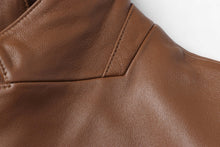 Cargar imagen en el visor de la galería, Close-up of REED Men's Premium Lambskin Leather Blazer showcasing soft, durable brown leather texture and stitching details.