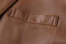 Cargar imagen en el visor de la galería, Close-up of REED Men's Lambskin Leather Blazer showcasing premium brown leather texture and stitching detail.