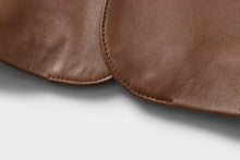 Cargar imagen en el visor de la galería, Close-up of brown lambskin leather from REED Men's Blazer Sports Jacket, showcasing soft-touch texture and premium quality material.