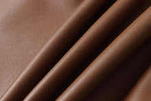 Cargar imagen en el visor de la galería, Close-up of brown lambskin leather fabric texture, highlighting its soft and durable qualities ideal for premium jackets.