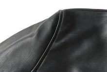 Load image into Gallery viewer, Close-up of black genuine lambskin leather from REED EST. 1950 Men's Jacket, showcasing premium craftsmanship and soft texture.