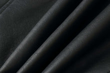 Load image into Gallery viewer, Close-up of premium black lambskin leather texture, highlighting the soft and luxurious quality of REED EST. 1950 jackets.