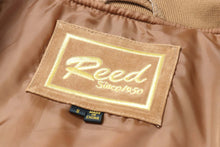 Load image into Gallery viewer, Tag inside REED Men's Baseball Suede Leather Jacket showing brand label and size. Made in China. Satin lining background.