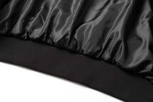 Load image into Gallery viewer, Close-up of satin lining on a black suede leather jacket showing soft, supple texture and quality stitching.