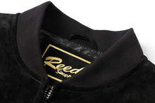 Load image into Gallery viewer, Close-up of REED Men's Baseball Suede Leather Jacket collar showcasing the brand label and black suede material.