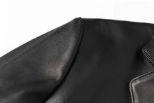 Cargar imagen en el visor de la galería, Close-up of REED Men's Premium Lambskin Leather Blazer showcasing soft-touch durable black leather.