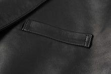 Cargar imagen en el visor de la galería, Close-up of black lambskin leather texture on REED men's blazer, showcasing premium craftsmanship and soft-touch feel.