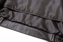 Cargar imagen en el visor de la galería, Close-up of REED Men's black New Zealand lambskin leather jacket showing soft interior lining.