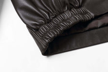 Cargar imagen en el visor de la galería, Close-up of REED Men's New Zealand Lambskin Leather Jacket sleeve showing soft, black lambskin leather texture and craftsmanship.