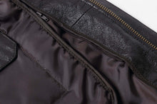 Load image into Gallery viewer, Close-up of the interior lining and stitching of a REED Men's Premium Leather Aviator Bomber Jacket.