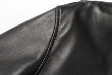 Cargar imagen en el visor de la galería, Close-up of REED Men's New Zealand black lambskin leather jacket showcasing fine stitching and luxurious material texture.