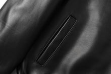 Cargar imagen en el visor de la galería, Close-up of black New Zealand lambskin leather jacket by REED with smooth, soft-touch finish, highlighting fine craftsmanship.