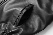 Cargar imagen en el visor de la galería, Close-up of black New Zealand lambskin leather jacket pocket from REED, featuring smooth, soft-touch finish and crafted design.