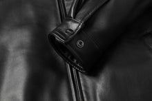 Cargar imagen en el visor de la galería, Close-up of black REED Men's New Zealand lambskin leather jacket cuff and zipper detailing for style and comfort.